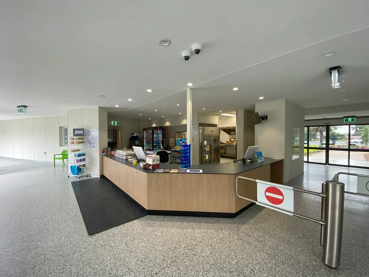 Reception area of a commercial building with recessed downlights and security cameras