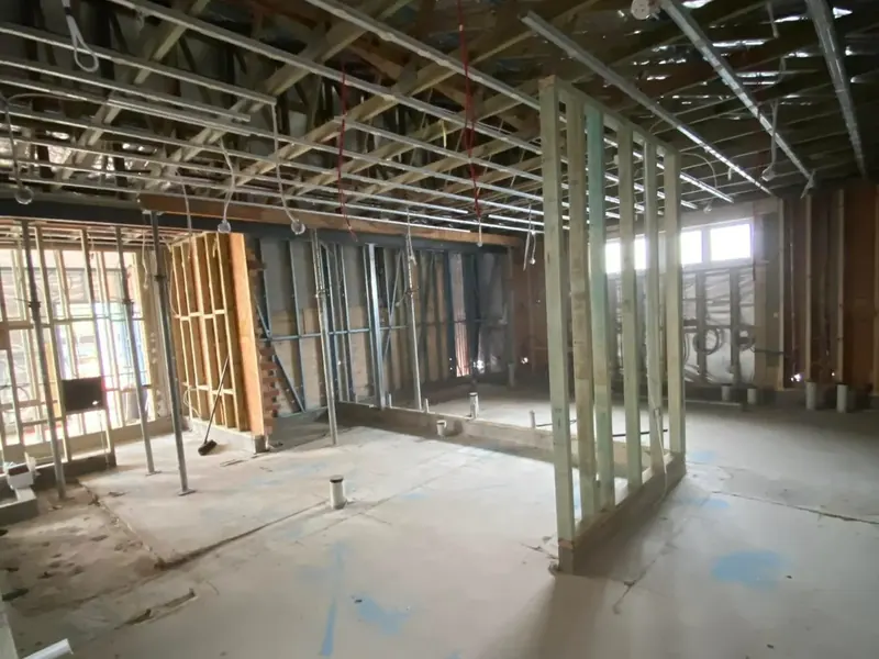 A large commercial space under fit-out with conduit run through the ceiling frame