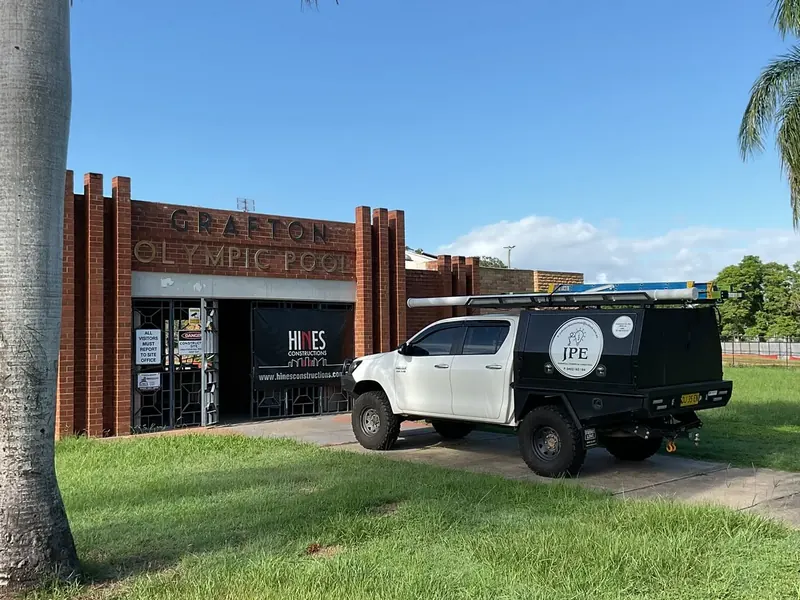 The Justin Purdey Electrical ute parked outside the Grafton Olympic Pool
