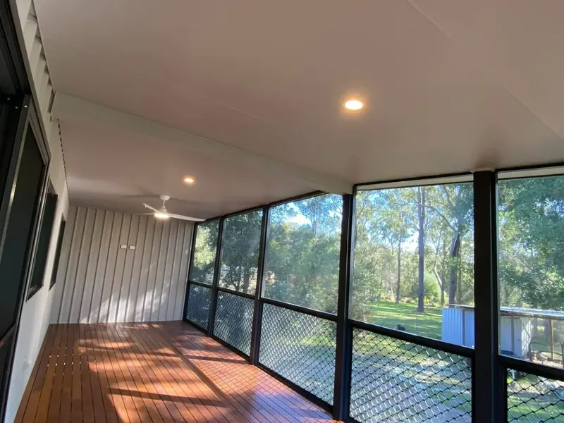 An enclosed verandah with recessed downlights and a polished timber floor